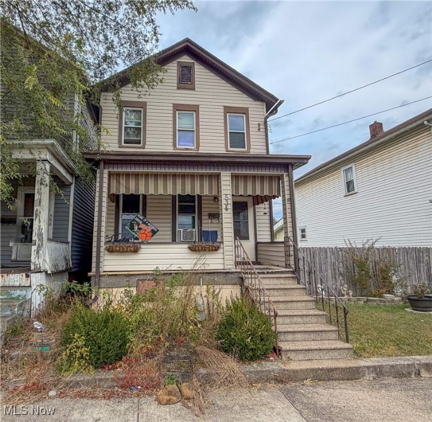 Conveniently located on the tri-state border of Ohio, West Virginia, and Pennsylvania. Two-bedroom one-bathroom home with private parking in the rear. The front of the house has a covered front porch spanning the width of the home. The first floor has a living room, dining room, and kitchen. Upstairs, the home has a full bathroom and two bedrooms. The house sits on a full basement. The laundry is located in the basement. Out back, the home has a small fenced-in yard, a carport, and a back porch.