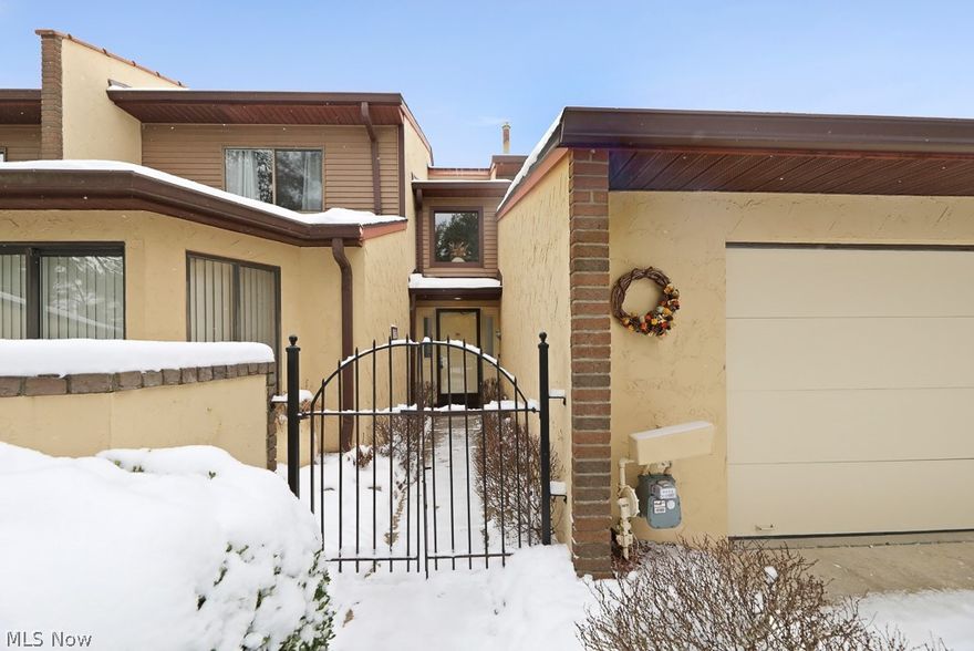 Enter this sprawling condo into the large foyer with wood flooring. The master suite is off the foyer with access to private garden area at the front of the unit. The master suite has two walk-in closets with dressing area with sink and large bath area with jetted tub and separate shower. Straight ahead on the left is the enclosed bar area with mini-fridge and glass shelving. At the end of the foyer is the massive carpeted  great room with cathedral ceilings and fireplace at the left end. Loads of windows allow lots of natural light in from the rear along with access to the patio. The adjacent room could be a formal dining room or family room with wood floors and doors to the patio and it’s also open to the kitchen. The kitchen has loads of storage, open space for microwave in the painted original cabinets, and laminate flooring. There’s great cubby storage under the stairs. Between the kitchen and the attached garage entry is a laundry area with coat closet and two closets with shelving. Between the kitchen and foyer there is another hallway with a large coat closet and half bath. Upstairs you are greeted with an open loft area with overlook to the foyer and great room below. On this floor you will find three carpeted bedrooms and another full bath. The smallest bedroom has an attached walk-in closet and built-in shelving. The location of this unit is really beautiful with the water feature directly beyond the large brick patio. Come and enjoy all the benefits of this lovely condo association