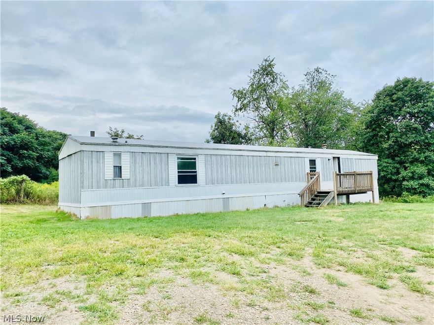 Private & Secluded 9.99 Acres with a  2 bed, 2 bath--14 x 70 1994 mobile home (needs some TLC), 30 x 40 pole barn & 8 x 10 shed. On property is also area to Park an RV or Camper.