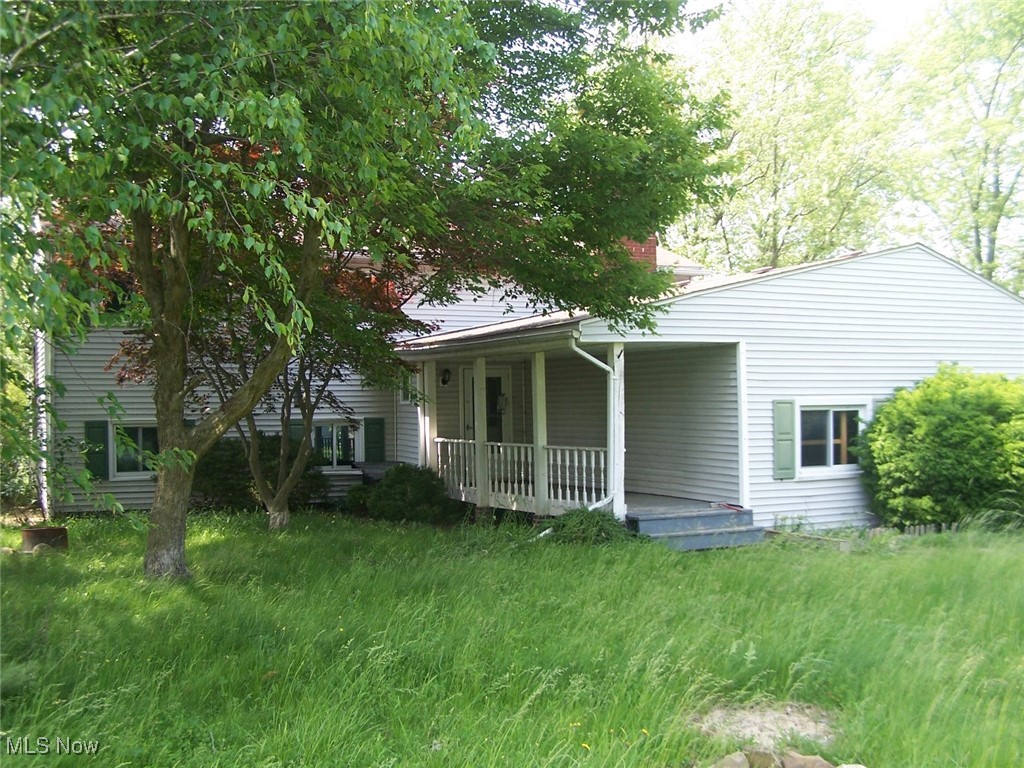 Spacious bi-level with 3-4 bedrooms. Fourth bedroom is located on the lower level with full bath, utility room and family room. Updated vinyl flooring in kitchen and baths. Main floor living room has a fireplace. Lower level has potential for woodburner with brick hearth. Needs some TLC, but great potential.