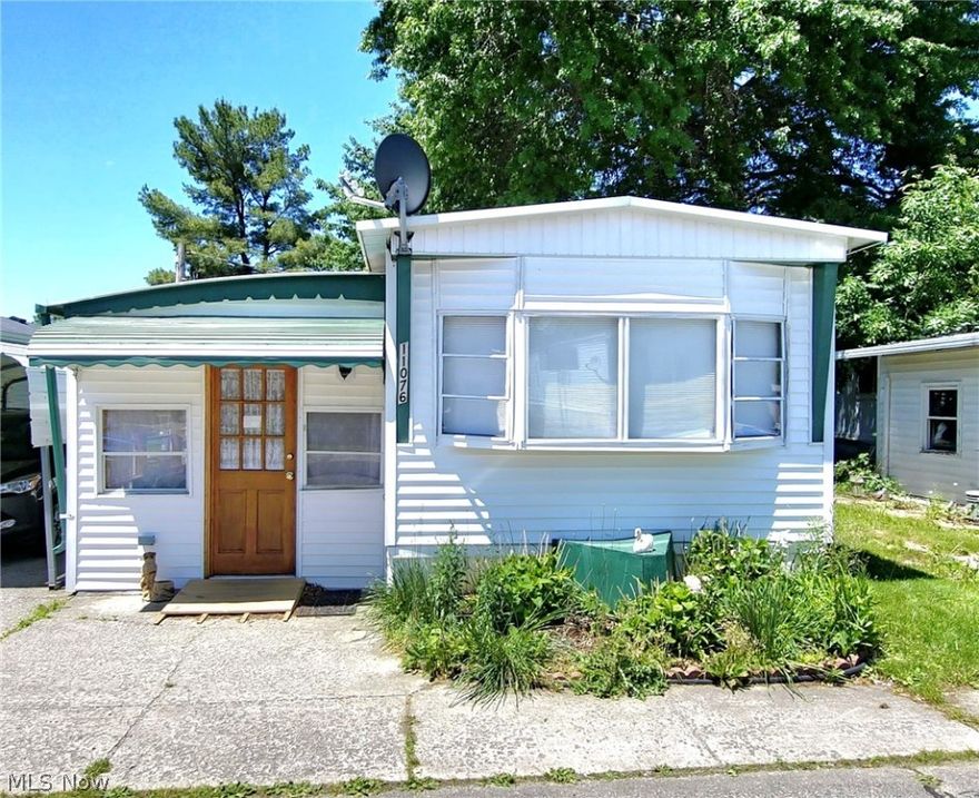 Welcome home to this well maintained 2 bedroom, 1 bath mobile home. Park your vehicle under the carport and enter through the carpeted sun room which is also wheelchair accessible and has access to the rear covered porch and patio to relax and enjoy the yard. You will find a nice sized living room, dining area with built-ins and nice updated kitchen which includes appliances. Two bedrooms and a full bath with walk-in shower. Buyer must be approved by management by filling out the application online. All furniture can stay. Call your agent for your private showing.