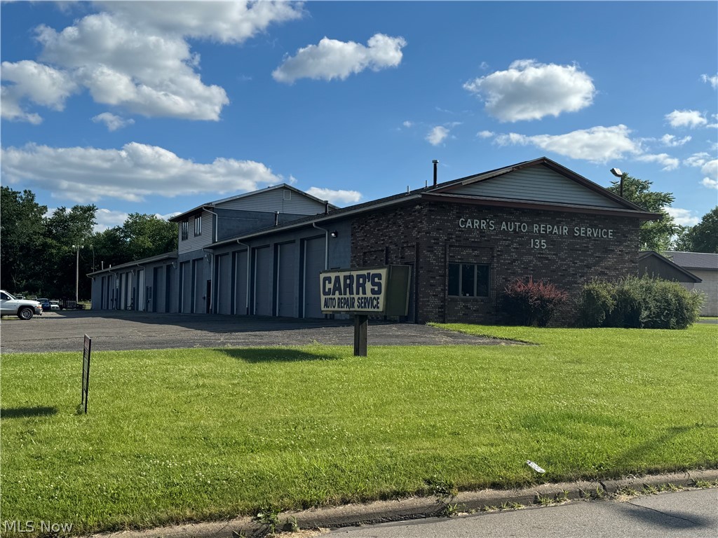PRIME LOCATION! Currently operating as a fully-leased auto repair shop, this 9000+ square feet brick and concrete building is situated on nearly an acre of land. The possibilities here are endless, featuring 14 bays currently utilized as six separate units leased to various tenants. Unit #A (First 5 bays) includes two ground lifts, one electric lift, air compressor, waste oil burner, 20x10 office and a storage room with 2 bathrooms. It rents for $2,500 per month. Unit #B (2 bays + a 900 sqft apartment on the second floor). The newly-remodeled apartment offers two bedrooms, one bath, all new appliances, garage with commode and gas furnace. Unit #C (2 bays) includes an office and commode. It rents for $300 per month. Unit #D (1 bay) with commode, rents for $100 monthly. Unit #E (2 bays) with commode, rents for $300 per month. Unit #F (2 bays) measures 50x 30 with commode, rents for $300 monthly. Whether you need the entire 9,000+ square feet for your business or you want to utilize the income-producing "suites," this is the building for you.