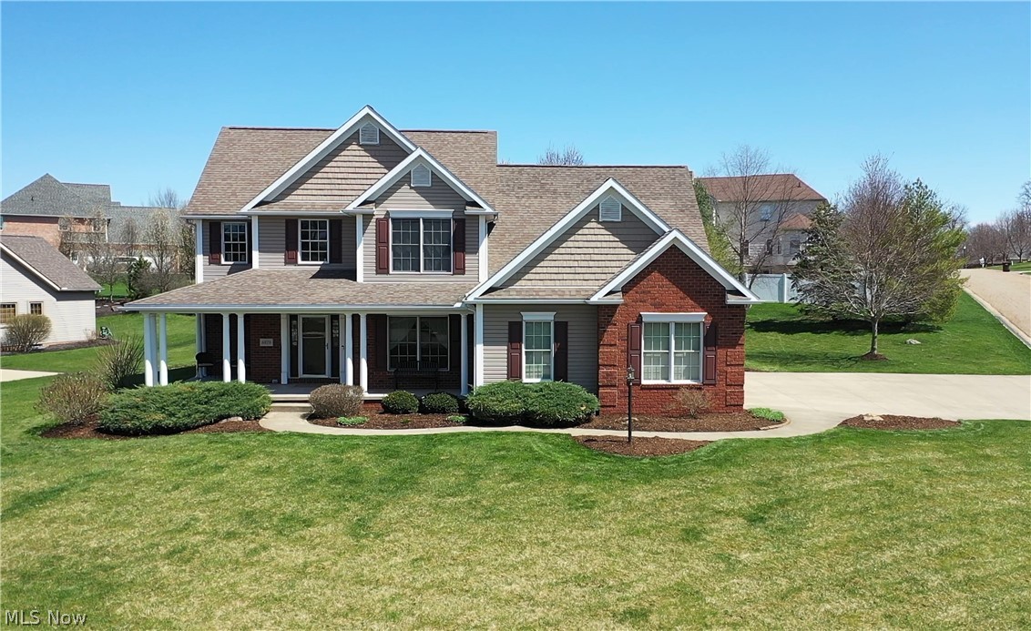 Welcome to this Beautiful four-bedroom home in Wellington Woods in Plain township. This gorgeous home is immaculate, spacious, bright & airy, with an inviting front porch. An open floor plan welcomes you as you enter this grand two-story/Great Room with ceilings 22 feet high and an incredible gas fireplace is a beautiful focal point. The great room opens to the spacious eat-in kitchen with Bolon's hickory cabinets, ceramic flooring, granite counters, stainless appliances, a breakfast bar, and a dining area with sliders to the patio. Convenient 1rt-floor master suite complete with deluxe bath, his and hers sinks, corner soaking tub, separate shower, and extra-large (13x8) custom walk-in closet with built-in shelves. A formal dining room, half bath, and convenient laundry with utility sink/closet/cabinets & access to the three-car side load garage complete the main floor. Enjoy the view from the catwalk to the great room on the 2nd floor that offers three bedrooms with large closets and