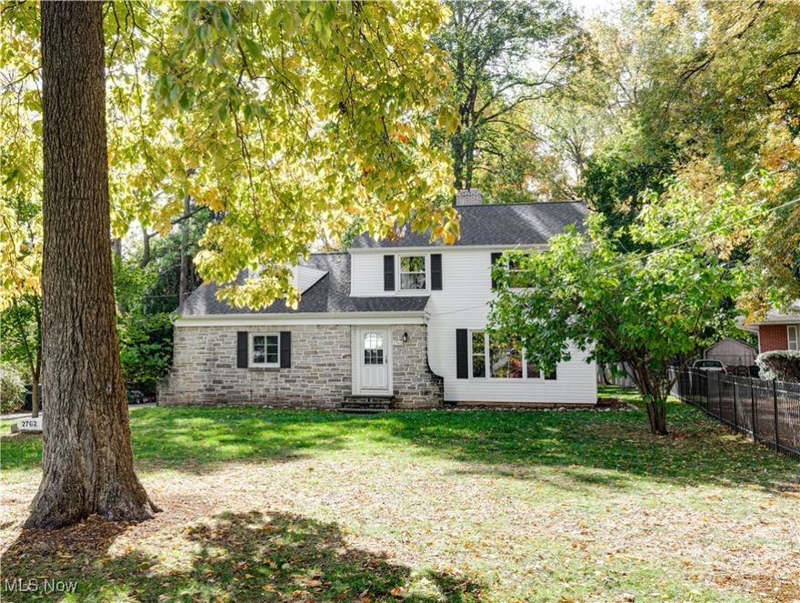 This gorgeous colonial home, nestled on a huge city lot- boasts 3-bedrooms, 1.5-baths, finished basement and attached garage! The front foyer welcomes you into this spacious main level boasting white oak hardwood floors, original woodwork and beautiful fireplace. The spacious living and dining rooms offer plenty of natural light and an open feel, perfect for everyday living and entertaining. The kitchen has been updated to include tile backsplash and new appliances. A cozy family room/den and half bathroom round out this impressive level. White oak floors continue on the second level where you'll discover an updated full bathroom and 3 very spacious bedrooms, all with large closets and ample natural light!  The finished Basement offers additional living space and recreation room along with ample storage! This home's setting is unmatched on over .80 acres of gorgeous property. This park-like setting is ideal for gatherings, gardening, or relaxation. Notable improvements include a New Roof (2025), New Vinyl Siding (2025), New Windows (2024), Flooring throughout (2024), Fresh paint- lighting and plumbing fixtures throughout (2024), New bathroom (2024).  Located just minutes from downtown Cuyahoga Falls, this home offers easy access to shopping, dining, parks, and entertainment. A wonderful opportunity to own a home that combines character, space, and convenience.