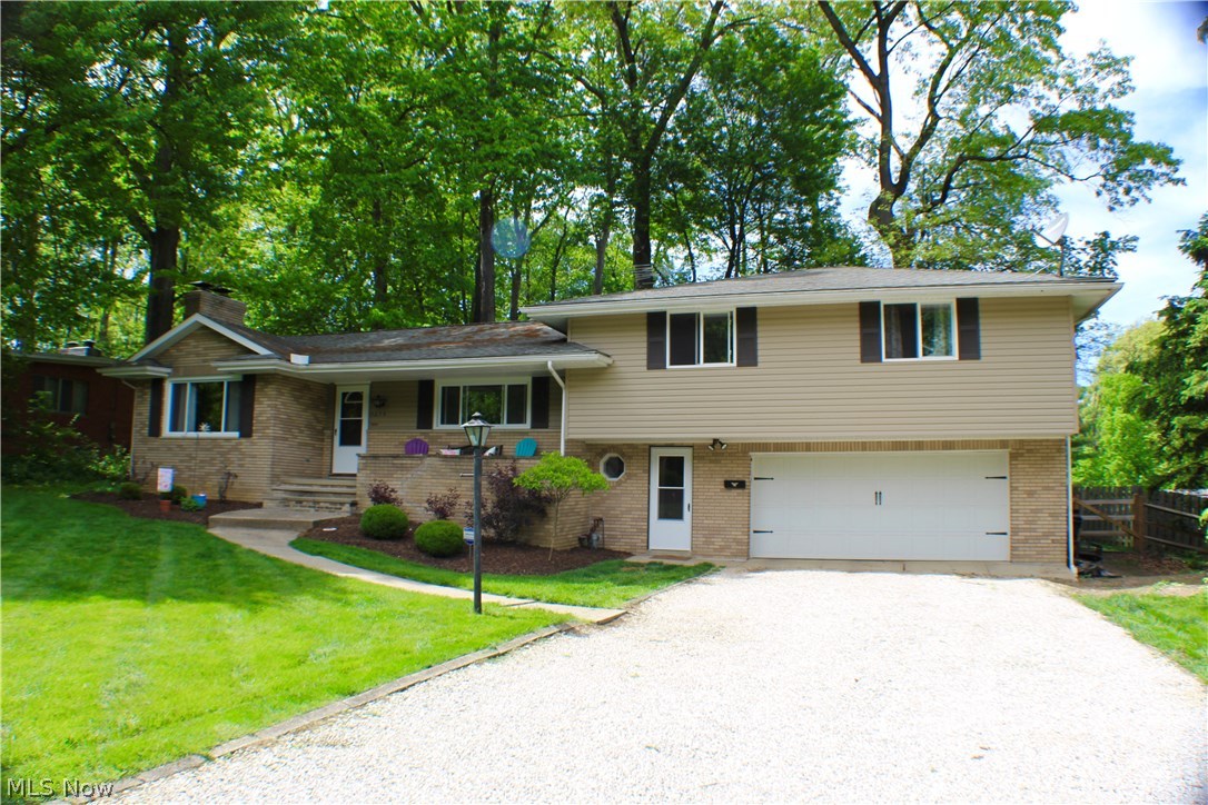 Welcome to 1275 Winhurst Drive. Fully updated home in West Akron is a MUST SEE! Spilt-level home offers LOTS of space! Family room features a large picture window & a gas glass fireplace, opens to a formal dining space. Kitchen features gorgeous cabinets granite countertops stainless steel appliances. Sliding glass door opens to a wooded fenced in backyard. Also on the main level is a large office space with built-in. Upstairs features 3bedrooms & 2 full baths. Walk-up attic storage space. Lower level features large mud hall w/ closet storage & 1/2 bath right off of the 2 car garage. Basement has large rec space featuring fireplace. Barndoor opens to laundry & storage area. This home won't last long. Call TODAY for a showing!