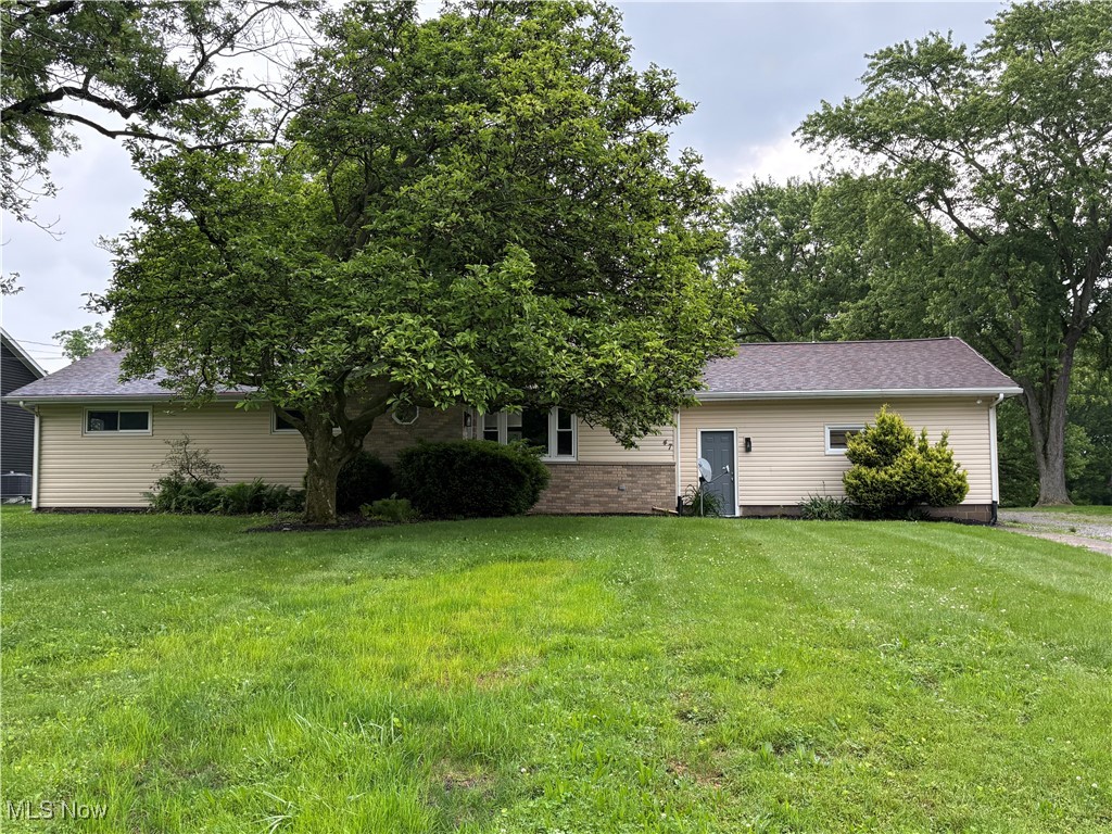 Spacious updated Ranch with 5 bedrooms. Over a half an acre of land and a 4.5 car garage. Large Eat-in-Kitchen with tiled back splash. It is centered between a large Morning room and a Great room with a shiplap accent wall. Three bedrooms with 2 full remodeled/updated bathrooms. The Master suite has a walk-in closet with a private full bath and tiled shower. Lower level with a large rec room and a fireplace. Two decent sized bedrooms on each end. Another full bathroom in the basement with a new epoxy floor. Laundry closet and large storage room with new epoxy floor. Outside has an attached 2 car garage and a detached 2.5 car garage with attached screened in porch. Beautiful yard to see all the wildlife. Updates include many new windows, exterior doors, flooring, recessed lighting, garage door on detached garage. Whole house painted on May 25 with new carpet in basement on the same day. Must see! Don't miss this one!