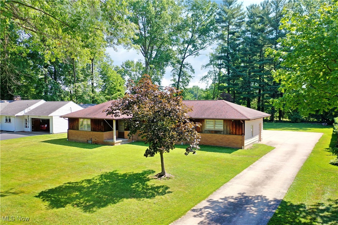 This gorgeous, three-bedroom Warren residence offers up stunning looks and clean, living space with both its spacious and updated interior and impressively sized lot. Nestled into a quiet neighborhood the grassy property extends along the concrete driveway that leads up to the home. A large turnaround is located behind as reward garage entry overlooks the casual, skylight lined sunroom. Through the front door, elegant hardwoods fill the living room as natural light pours in from the forward picture window. A stone woodburning fireplace with full mantle awaits just outside of the dining room. The eat-in styled location joins the loon running kitchen as it enjoys a mix of stained wood cabinetry and bright stainless work. The wrapping main hall runs past a trio of inviting bedrooms along with a brightly colored bathroom. Down below, a full basement offers laundry and storage to pair with readily available potential living space and a finished rec room with fireplace and half bath.