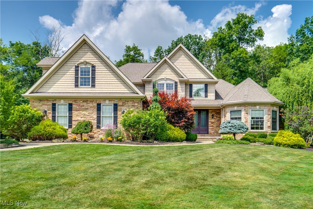 Nestled on a private cul-de-sac in the desirable Highland Meadows Subdivision, this exquisite custom-built home offers over 5,500 square feet of finished living space, surrounded by lush woods and meticulous landscaping, creating both privacy and stunning curb appeal. Inside, the home is a showcase of quality craftsmanship, rich woodwork, and thoughtful design. The main level features an open layout with vaulted ceilings in the great room, anchored by a wood-paneled fireplace with a stone surround. A formal dining room and a private home office with turret style ceiling and wood beams offer elegant and functional spaces, while the chef’s kitchen impresses with a beautiful, coffered ceiling, granite countertops, stainless steel appliances, pantry, spacious eat-in bar, and seamless flow into the great room. Just off the kitchen, you’ll find a mudroom and a spacious laundry room for everyday convenience. The first-floor owner’s suite is a luxurious retreat with a spa-like ensuite bath, complete with dual granite vanities, a jetted tub, and a custom tiled steam shower with multiple shower heads. Upstairs you’ll find a large open loft overlooking the main living area, surrounded by three additional bedrooms. One bedroom measures 26 x 15 with an ensuite bath. Another bedroom offers a built-in desk and shelving. Just off the loft is a full bath. The fully finished lower level adds 1,758 square feet of high-end living space, including a large family room with a modern LED fireplace, a gaming area, workout room, and a full bath. Step outside to your private backyard oasis—complete with a serene rock waterfall, a gas-fed fire pit, and mature trees providing natural seclusion. Additional features include: 12-zone sprinkler system, Invisible pet fence, security system, hot water tank (2020), wired for whole house communication system and so much more. This home is a rare find—blending high-end finishes, quality construction, and peaceful surroundings in a prime location.
