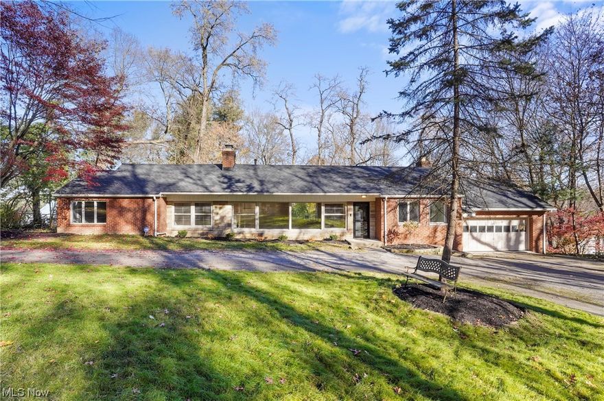 Fairlawn Hts. beautiful ranch with walk-out lower level, tucked away in a private, wooded setting on 1.97 acres (3 parcels). This all brick and stone home features hardwood floors, an open floor plan and contemporary color palette.  A spacious living room, with wall of windows, fireplace and space for dining welcomes you.  The updated kitchen highlights Kraftmaid cabinetry, granite countertops, SS appliances and center island.  Cozy dining nook off the kitchen.  Off the back of the home there is a all season sunroom and deck open to the fenced in backyard.  The master bedroom includes an private ensuite bathroom with shower.  Two additional bedrooms and updated main bath with double vanity, granite countertops and tub/shower combo. The walk-out lower level boasts a spacious family/recreation room, fireplace, a modern 3rd full bathroom and lower patio perfect for entertaining.  Two car attached garage.  Recent updates include: roof, spray foam insulation added in attic and fence all in 2020 and fresh paint on the main floor, 2023. Walk to local restaurants and shopping and close to the parks. Make this your home for the holidays!