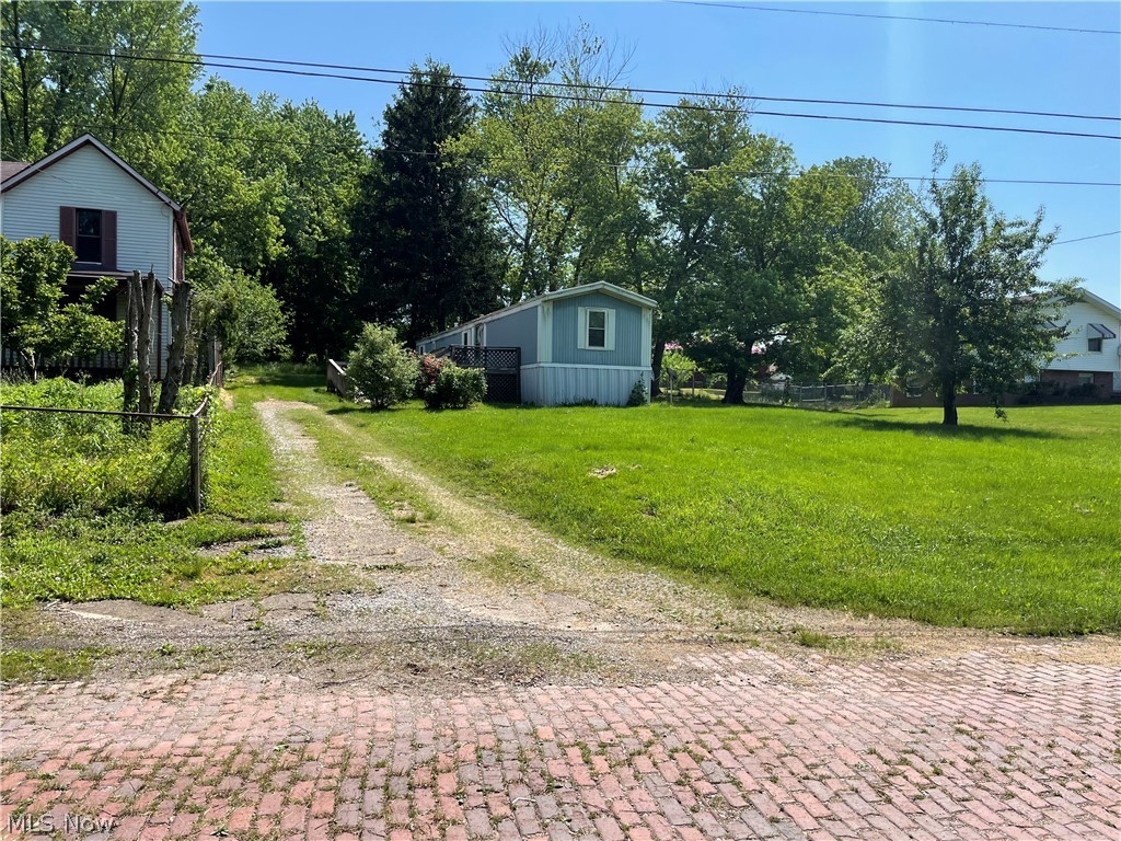 Nice Investment Opportunity awaits you! Looking for a place to use as a rental and obtain land with it to possibly add more rentals? All utilities are available to add additional home sites. This single wide has 3 bedrooms and 1 full bath. Laminate flooring in most and carpet in two of the bedrooms. There is plenty of parking plus an additional parcel that goes with this as well. This was previously used as a rental and produced good rental income. Across the street where the separate parcel is located, there is a 1 car garage. The doors open and there is an electric garage door. Additional parking and previously used as an R/V parking space.
Possibilities galore! Call TODAY!