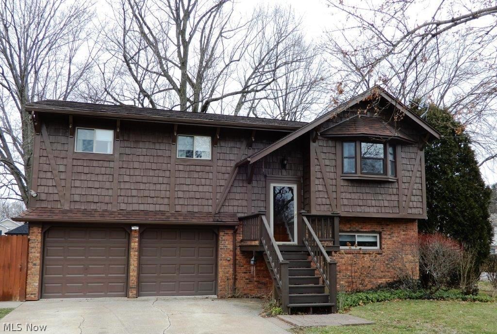 First time offered! You will absolutely fall in love with this custom-built 4 bedroom/2 full bath one owner home. Great curb appeal, and the pride of ownership is evident from the time you walk in the front door. Not your traditional bi-level floor plan, the main living area features a bright and cheerful eat-in kitchen with recessed ceiling and huge skylight! The formal living and dining rooms have a beautiful vaulted ceiling, and neutral decor. There are even stairs in the back that lead down to the family/recreation room - very unique and functional! The main floor is completed with a large full bathroom, ample master bedroom, and 2 additional bedrooms. The kitchen, bathroom, and all bedrooms on the main level have real hardwood flooring! Venture downstairs and you will find an awesome family/rec room w/wood burning stone fireplace (back stairway up to the kitchen), full bathroom, a true 4th bedroom, and laundry room! Attached 2 car garage w/workshop area, and two doors that l