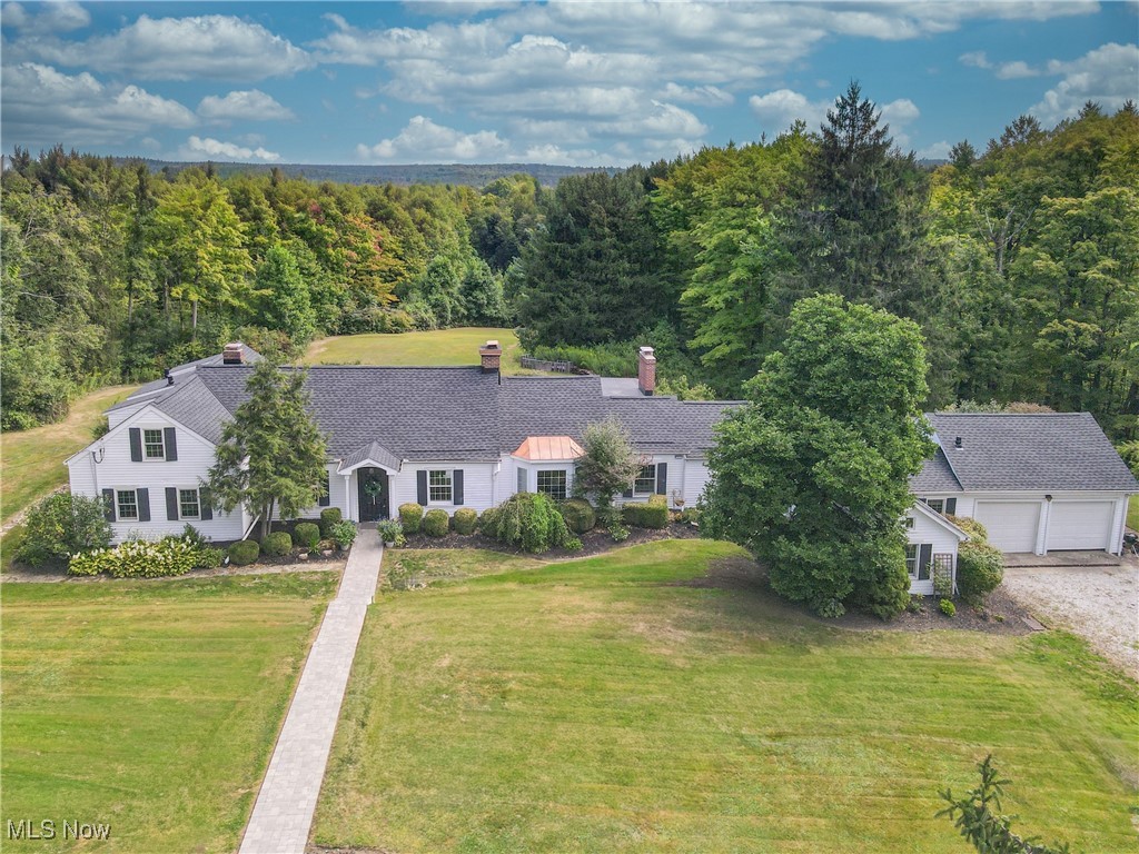 This is truly a one of a kind property situated at the end of a semi private lane surrounded by 17.5 acres of scenic privacy, pastures, woods and streams! With many recent upgrades, this home is the perfect blend of classic charm and tradition with today’s modern amenities. Enter the impressive living room with hardwood flooring and trussed cathedral ceilings. The large wood burning fireplace is accented with a mantle dating to the late 1700's and the large windows allow an abundance of natural light. The formal dining room continues with hardwood flooring and a bay window, perfect for entertaining family and friends. The chef in the family will delight in the well equipped chef's kitchen with newer top of the line "Cafe" appliances, a center island breakfast bar and another cozy fireplace. Offering nonstop views of the property, the spacious family room has brick flooring, another wood burning fireplace and spectacular mantle, newer windows and a door to the back patio. The primary suite is tucked away for privacy on the first floor with hardwood flooring, private bath, another bay window and Dutch door to the patio. Another bedroom is found at this end of the home, which would be ideal for a home office or study. The first floor has another secluded bedroom and bathroom off the kitchen and the laundry is found there as well. The second level of the cape cod style house has two bedrooms and a third full bath. Outside, there are two patios, a four stall horse barn with two fenced pastures and a rustic "playhouse". New roof among other fantastic improvements! Welcome Home!