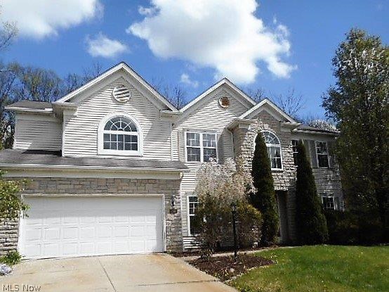 Brunswick Colonial With Stone & Vinyl Exterior Has Loads Of Curb Appeal! Features 4 Bedrooms and 2.5 Baths! Located At Top Of Cul-De-Sac Street and Nestled On Wooded Lot! Grand Foyer Entrance With Columns and Wood Floor Greet You As You Enter! Two Story Great Room Boasts Stone Fireplace Flanked By Shelving With Window Wall! Kitchen With Wood Floor and Island. Wood Flooring Found Through Most Of First Floor. Convenient 1st Floor Laundry Room! Formal Dining Room Perfect For Dinner Parties. Master Bedroom With Vaulted Ceiling and Master Bath With 2 Sinks, Soaking Tub and Walk-In Closet. Full Basement Provides Plenty Of Storage and Potential For More Living Space. Relax On the Deck Overlooking Wooded, Partially Fenced Private Lot.