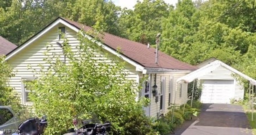 INVESTOR SPECIAL! Located in the one, the only, beautiful Amherst Ohio in the Township section of the city water and sewer, you get the location you've always dreamed of in this quaint 2 bedroom, 1 bathroom single story home, sitting on a slab foundation. Vinyl siding, a back deck area, a rather large garage for parking plus a workshop area and two shed located at the back of the property. Roll up your sleeves and add that sweat equity as this is priced to sell fast! Schedule your showing today!