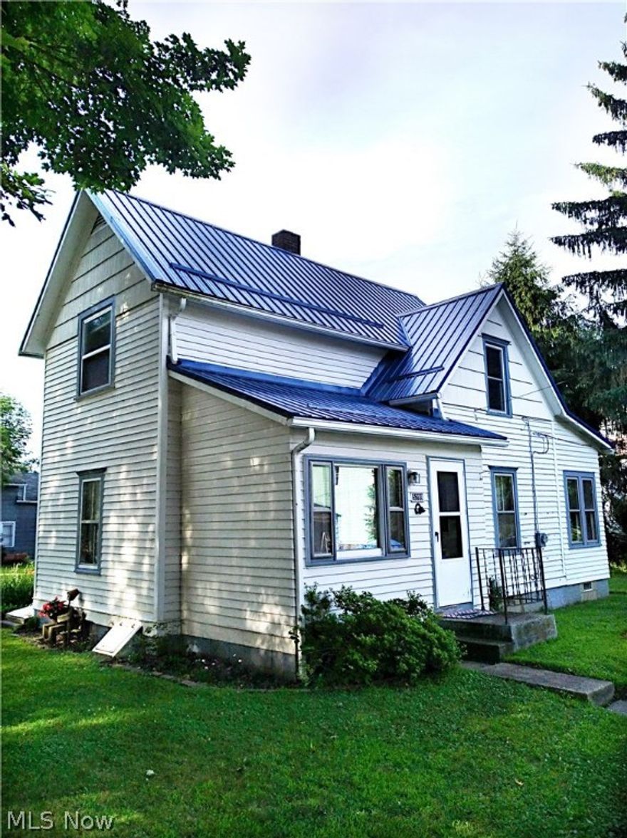 You can have it all!  Close to shopping and amenities, yet a country feel.  This property offers the best of both worlds with a country setting! A gorgeous new metal roof (2017) and furnace (2015) have been replaced. Walk into the front door to new carpet in the living room and dining room.  The roomy kitchen boasts newer cabinets and overlooks the charming side yard.  Rounding out the first floor is the full bath and bedroom.  Two more bedrooms are upstairs along with ample closet space nestled in the eaves.  New block windows with ventilation have been installed in the basement. There is a 20 x 18 two story barn that has electric, (could be used as a 2 car garage) an attached dog kennel with inside access and 2nd story storage.  This charmer won't last long.  Call your favorite realtor today!