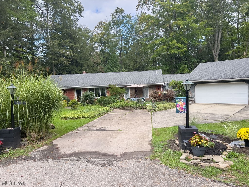 Welcome to this private park like setting in Kirtland. Situated on 3.5 acres of private woods overlooking the ravine below. This 3 bedroom 2 full bath home has an updated kitchen, updated primary bathroom, additional sunroom/3season room between the garage and home, featuring a gas burning stove. Furnace replaced in 2020, Septic has been inspected and cleared, Roof is approximately 15 years old, Pella and Anderson windows updated in recent years. Come check it out!