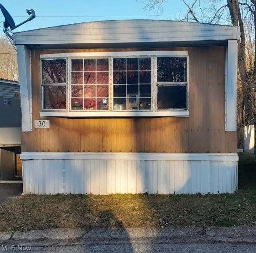 Spacious Starlite Fairmont mobile home with 2 bedrooms on opposite ends of the home.  Full bath with tub.  The half bath is in the front bedroom.  Open floor plan, the 4 major appliances stay.  Seller put $11,000 into home including the living room floor and back bedroom floors replaced 3 years ago, widened front steps and porch 3 years ago, furnace replaced 10 years ago, roof sealed 1 year ago, and water heater 2012. 
 Must be approved by Park - application is $50.  Pets permitted:  2 cats & 2 dogs less than 35 lbs.  The outdoor lift does not stay.