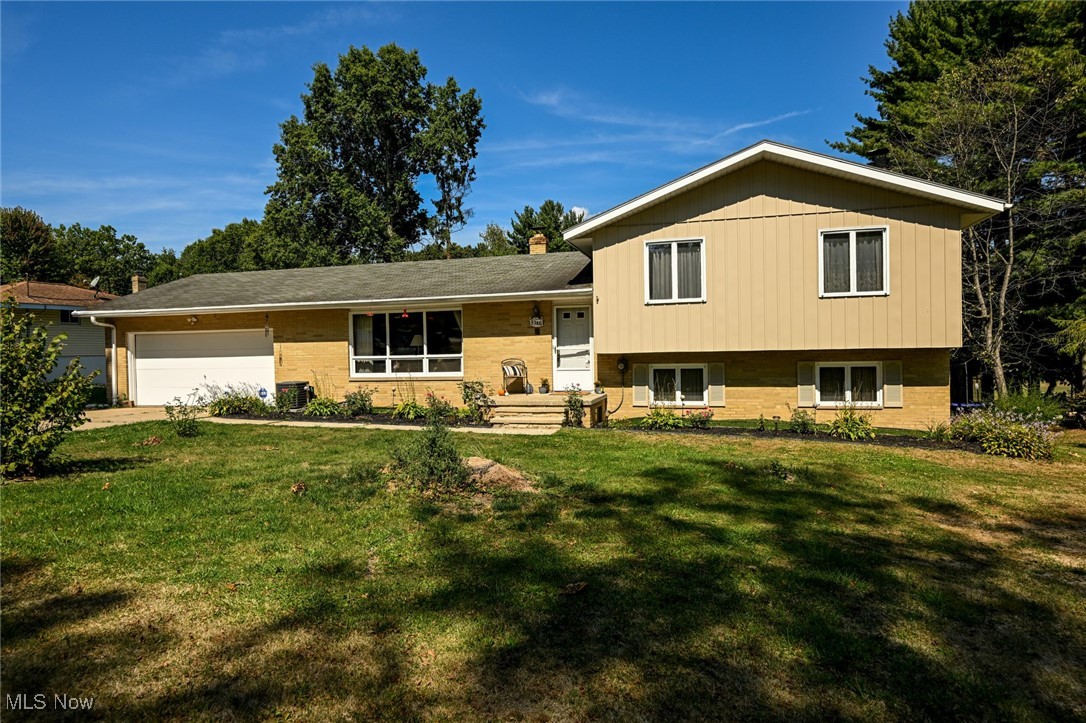 LOCATION, LOCATION, LOCATION! Don’t miss this chance to own 2 acres in the highly sought-after Manchester School District. This split-level home offers 4 (possible 5) bedrooms, including 3 upstairs with hardwood floors and generous closet space, plus 2.5 baths. The master suite features sliders to a private balcony. The lower level includes a family room with wood-burning fireplace, enclosed sunroom, and two versatile rooms for bedrooms, office, or hobbies. Off the garage, a spacious rec room opens to a newer patio. Outside, enjoy a wooded ravine, newly cleared landscaping with rose bushes, a small pond, apple and pear trees, and grapevines. Plenty of open land for a garden, RV parking, or recreation, plus an oversized 2-car garage with rear storage bay and an additional detached 2-car garage. Updates: furnace & A/C (2021), hot water tank (2024). Nearly move-in ready and awaiting your finishing touches!