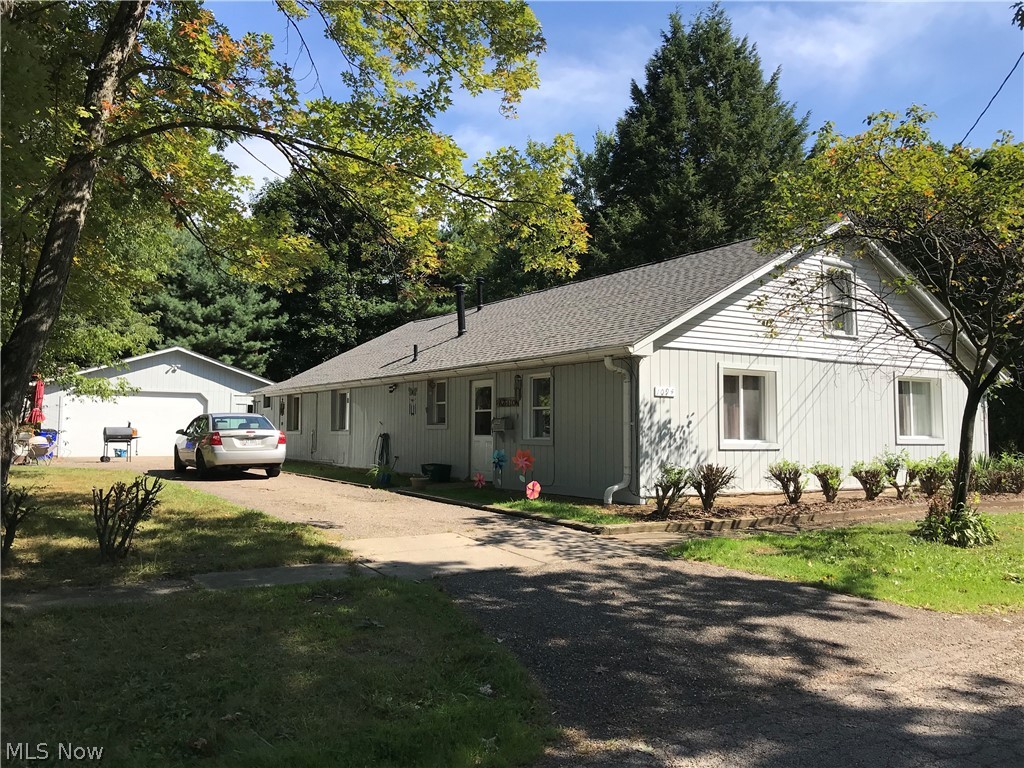 Looking to step into multi-family property ownership or expand your rental portfolio? This ranch duplex is in an established, mostly single-family neighborhood close to Brown Middle school. Close to the PARTA Bus Line, parks, downtown Ravenna and just a short 10-minute drive to Kent State University! Rent one side/live in the other...live in one side and have a family member live in the other... Have your college student live in one side & rent the other (cheaper than the dorm!) ... or rent both sides! New 30-year roof with complete tear-off & transferrable warranty (duplex plus detached garage), new exterior paint were completed in August 2019! Landscaping touched up both around units and in back yard. Solid concrete block construction overlaid with T-111. Newer flooring in both units~ one with slate and wood; the other with laminate wood and new carpeting in laundry and 1 bedroom. For the mechanic who wants a heated garage, there is a gas line in the SE corner of the garage waiting!