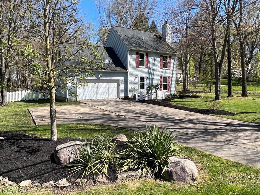 Feel right at home in this pretty, four bedroom colonial on 1.51 acres in Stow! This home has it all! Newly installed, beautiful luxury vinyl tile in the kitchen, hall, half bath, and living room. Kitchen has granite countertops and includes a wine cooler, stainless steel fridge, range, microwave, and dishwasher. Primary bedroom has a full bath ensuite. Living room features a fireplace with a gas log lighter. Off the living room is a light-filled sunroom overlooking a Koi pond with waterfall, fenced back yard, and peaceful woods. The park-like grounds have been professionally landscaped with newly mulched beds of flowering shrubs and perennials. The finished basement with luxury carpet is a perfect place for playtime, watching the game, or enjoying hobbies. Quiet neighborhood but minutes to Route 8 North and South for easy access to Akron or Cleveland. Third party appraisal completed May 21, 2024 and appraised for above list price. Don't miss out on this one!