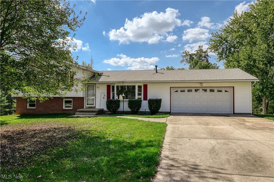 This split-level home, located in Brimfield Township, offers 1960 square feet of comfortable living space. It features 3 bedrooms and 2 baths. The attached 2-car garage provides convenience and extra storage. Inside, you'll find a formal dining room, a spacious living room, and a cozy family room with sliding glass doors that open to a deck, ideal for outdoor entertaining. Enjoy the enclosed sun porch, a perfect spot to relax and soak up the sun.