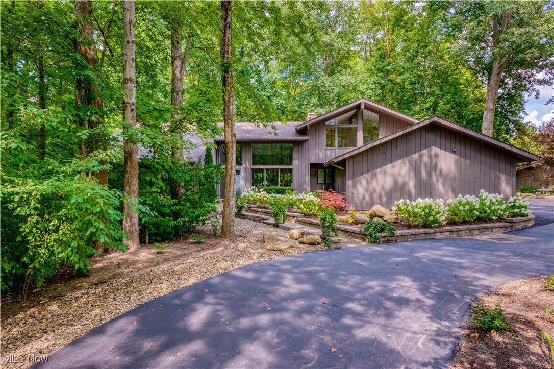 Prepare to be impressed by this beautifully updated home tucked away in a peaceful, wooded setting. From the moment you step inside, you're welcomed into an expansive open-concept layout featuring dramatic foyer, soaring ceilings & spacious great room and dining area. Floor-to-ceiling windows flood the home with natural light & frame breathtaking views of the surrounding forest, creating a seamless connection to nature.
At the heart of the home, the kitchen is both functional & stylish. Perfectly positioned between the dining area and cozy morning room, it boasts granite countertops, stainless steel appliances & resurfaced cabinetry completed in early 2024—an ideal space for cooking and entertaining.
The first-floor primary suite offers a true retreat, complete with dual 8x6 walk-in closets and versatile loft space, perfect for a lounge, office, or reading nook. The luxurious en-suite bath feels like a private spa, featuring a soaking tub & walk-in shower. Also on the main level is a spacious second bedroom, remodeled full bathroom, formal library or study with wet bar & a bright four-seasons room designed for year-round enjoyment.
Upstairs, you'll find a generous bonus room with floor-to-ceiling windows & wall-to-wall closets, along with a third bedroom with walk-in closet & additional full bath—perfect for guests.
This home has seen extensive recent upgrades, including new roof, gutters & downspouts (2023), Trex deck addition (2024), & new furnace, hot water tank & garage electrical panel (2025). Fresh interior & exterior paint completed in 2024 gives the home a crisp, modern appeal, while new white laminate flooring, plush carpeting & updated lighting throughout add comfort and style.
Enjoy all of this and the option to join the highly sought-after Walden Club, offering exclusive access to exceptional amenities. This is a rare opportunity to own a meticulously updated, move-in-ready home surrounded by natural beauty—schedule your showing today!