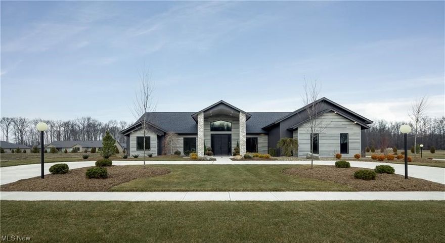 Introducing the magnificent Ridgefield model by the illustrious Bob Schmitt Homes, a beacon of architectural prowess w/ a legacy spanning an impressive 77 years. Recently crowned as the preeminent energy-efficient builder in OH for residences under 2500 sq ft, this residence is an ode to luxury & sustainability. Step into grandeur beneath soaring cathedral ceilings that grace the grand room, kitchen, dining area & entry. The grand room beckons w/ an in-wall fireplace, a beverage center featuring a wine refrigerator & a dining space. The kitchen boasts an island, ample cabinetry, solid surface countertops, a stylish backsplash, upgraded appliances & a walk-in pantry. The master is a sanctuary of indulgence, featuring a lavish tile & glass shower, complemented by expansive dual WIC. With a total of 3 bedrooms, 2.5 baths, an office adorned w/ extra storage, a home exercise room & a well-appointed mudroom. Architectural allure extends to the 16' x 10' covered front door entry & the 24' x 16' covered rear patio. The garage is a marvel w/ OH Garage Interiors flooring, hot & cold water, pegboard, pull-down stairs to overhead flooring & a laundry tub. This abode is a testament to forward-thinking w/ features like a sprinkler system, a 2 stage gas furnace w/ a variable-speed blower, a tankless water heater & bespoke entertainment & buffet cabinets. This lot is nestled in a community that boasts a clubhouse w/ a fitness center, an Olympic-size pool, a children's pool & a play area.