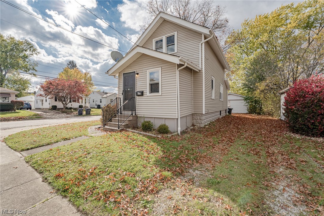 Great opportunity for a cozy colonial in East Akron! This charming home features 836 square feet of living space with 2 bedrooms, 1 bathroom, crisp neutral paint, newer carpeting, and more! The front door opens into a cozy bonus room that enters into the main living area. Here you will find a sizable living room that is open to the dining room. The adjacent kitchen includes a newer range and refrigerator, a lovely tile backsplash, and an eat-in area with plenty of sunlight and a built-in corner cabinet. A full bathroom at the back of the house completes the first floor. Upstairs, there are two surprisingly spacious bedrooms, both with ample closet space. The full lower level includes a laundry with updated appliances as well as plenty of storage space. Outside, there is a back deck with privacy fencing as well as a deep back yard with a 2-car garage. Conveniently located just minutes away from schools, parks, shops, and highway access. Don't miss out on this incredible value!