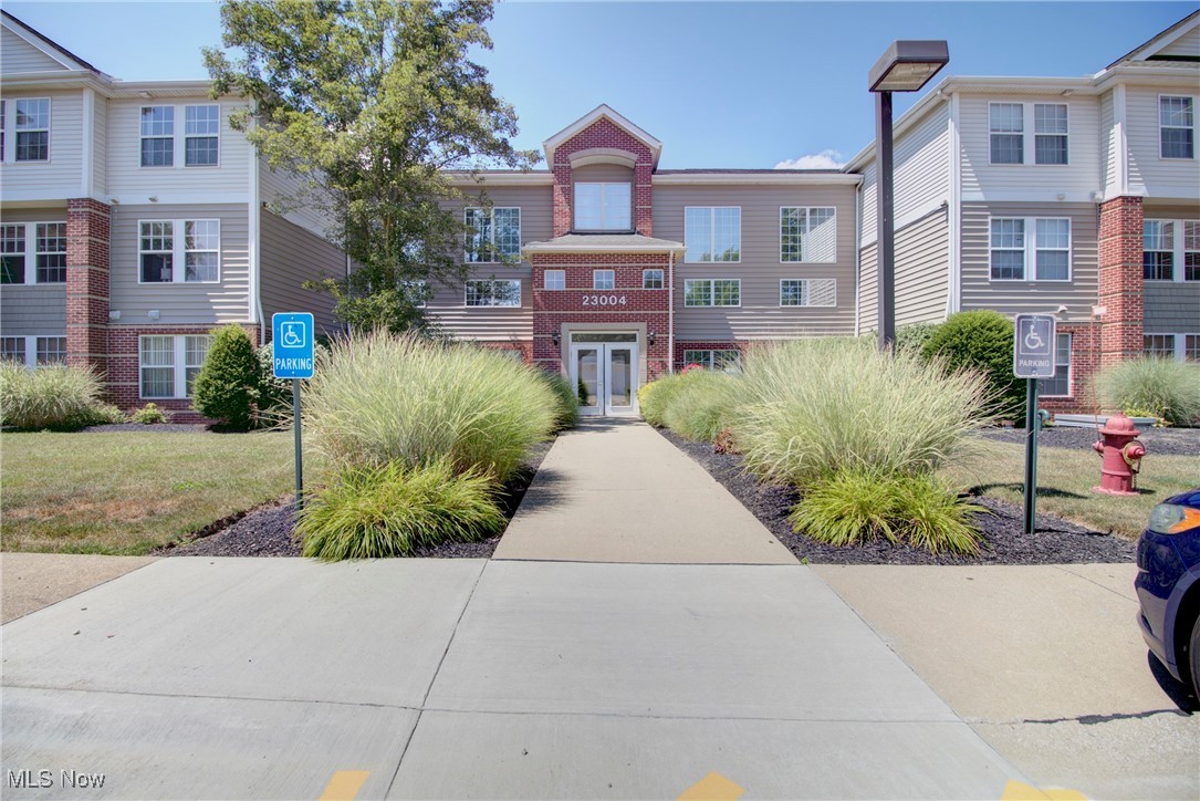 This lovely second floor, end-unit in one of Olmsted Falls' sought after condo complexes is definitely one to look at! This unit has a unique layout with the laundry and a hallway at the entry way and the steps are right next door with parking just outside! There are two large baths, one attached to the spacious master bedroom which has a large walk-in closet and the other with double doors where guests could use, but could also be closed off for private use to the second bedroom. This unit is nice and bright and offers an open concept amongst the living room, dining area and kitchen where there are plenty of cabinets and counterspace. There is a gas fireplace in the living room and sliders that lead to an outside balcony to relax while looking at the green space. A private garage space comes with the unit and is near to the rear entrance of the building. With elevators in the secured building, an in-suite laundry, a storage locker near the unit and plenty of space, this is a wonderful place for a first time home-buyer, someone looking to downsize or just maintenance-free living.