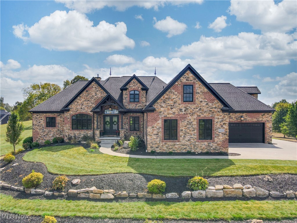Welcome to this stunning Hartville home located in the highly sought-after Lake Local School District! Offering 6 spacious bedrooms, this property combines elegance, comfort, and functionality. The heart of the home is a beautiful eat-in kitchen with massive island, custom walk-in pantry and incredible views, perfect for everyday living and entertaining. A huge great room with a cozy fireplace serves as the centerpiece for gatherings and relaxation. Luxurious details such as 12 foot and coffered ceilings, crown molding and premium appliances elevate the charm and character throughout. The huge master suite features soaring ceilings, direct access to the covered porch with a built-in fireplace, glamor bath with in-suite washer and dryer and 3 (three!) walk-in closets including a one-of a kind, speak-easy style custom closet & dressing room that you have to see to believe.
Convenience and thoughtfulness is maximized with laundry facilities on each floor, EV charging, and an invisible pet fence.
The walk-out basement with kitchenette, bar and movie room provides an amazing living and entertaining space, while the backyard is a true retreat featuring a sparkling pool with a brand-new liner and equipment, surrounded by a pristine yard ideal for gatherings and relaxation. A four-car, heated garage with direct access to the basement offers ample storage and convenience.