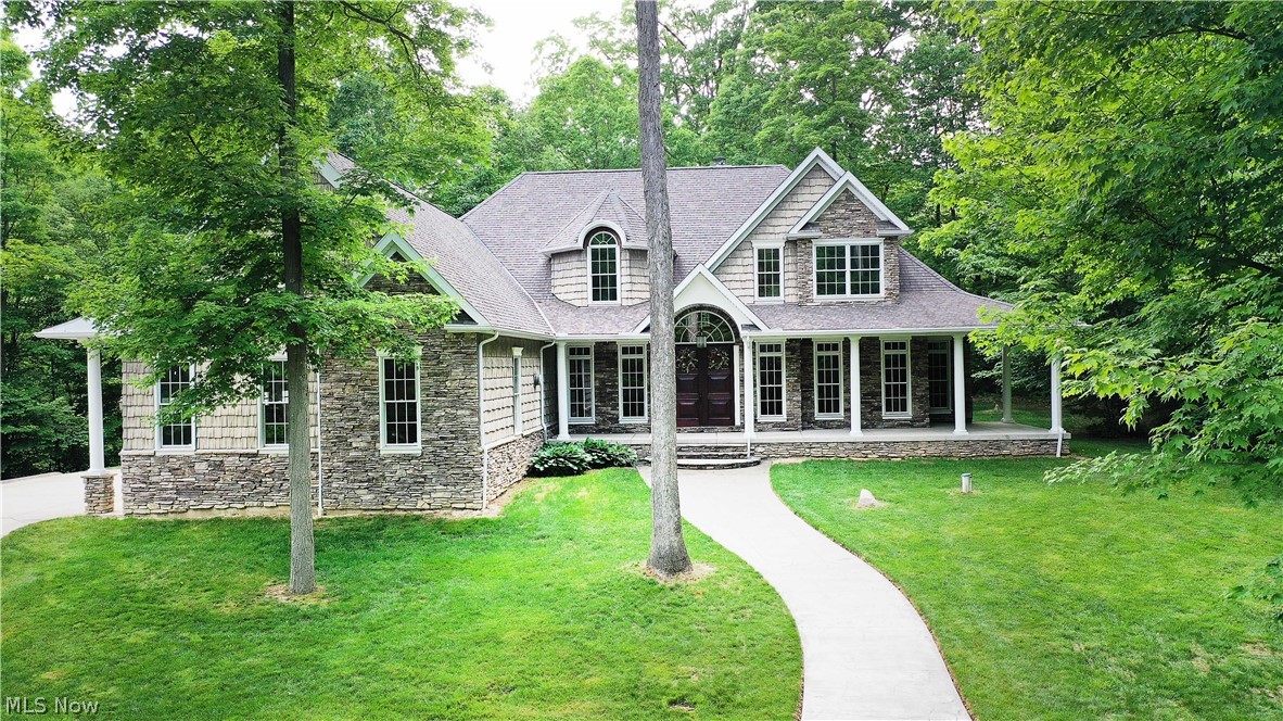 This fabulous custom-built home sits on 11-acres on a private wooded lot with a total of 3,903 sq.ft of living space. Fine craftsmanship and a well-designed floor plan come together in this gorgeous two-story home that has it all! Custom built-ins, hand-built beams, stone fireplaces, mudroom, natural ledge stone, & a great flow from room to room. The beautiful two-story foyer w gorgeous hardwood floors lead you to the great room w a wood-burning stone fireplace, 17' high ceiling, and a wall of windows w a perfect view of nature & access to the patio (w a stone fireplace). The gourmet kitchen is the heart of this home and the main gathering area for guests & family, featuring S/S appliances, granite counters, a massive island w a fabulous prep sink, double skylights, and vaulted ceilings. The eat-in hearth room is stunning w hand-built beams, a fireplace, a wall of windows, & amazing views. The Highly desired first-floor owner's suite offers a wall of windows w/a fabulous view, his/her