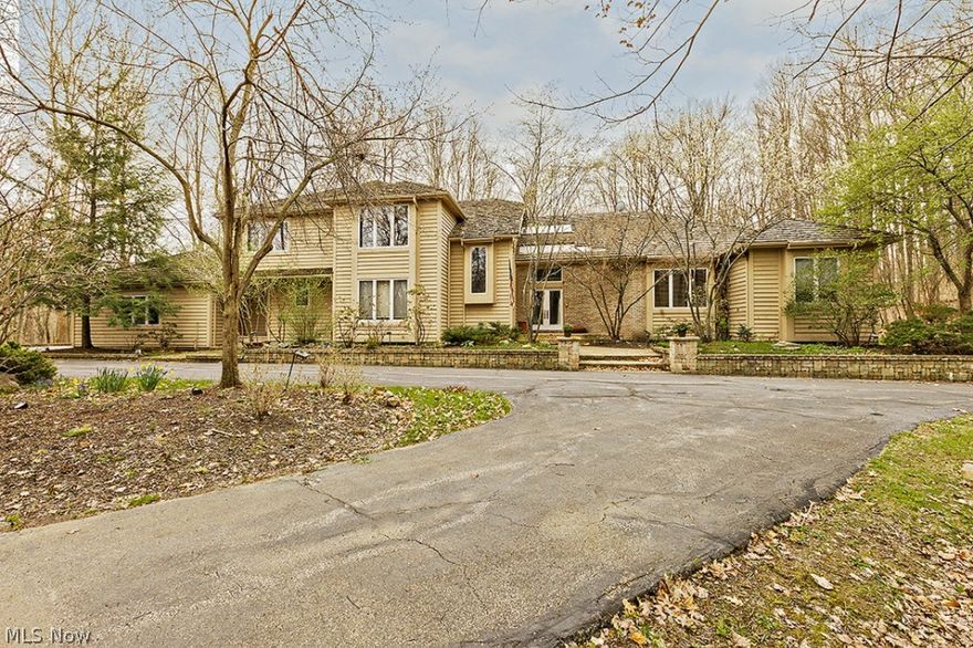 Elegance and sophisticated allure with unrivaled privacy abounds in this home sitting on it’s own hilltop. This transitional offers the versatility of any décor, from classic to contemporary, perfect for entertaining and living. The living room features built-ins, back patio access, and a double-sided marble fireplace. On the other side of the fireplace is a great room with a wet bar and wall of windows overlooking the beautiful backyard. The gourmet kitchen comes equipped with stainless steel appliances including a huge twin SubZero refrigerator/freezer, granite counters, and an eat-in area surrounded by windows. The banquet-sized dining room is perfect for formal dinners. The first floor master suite features a marble bathroom with glamour tub, as well as separate walk-in closets, vanities and water rooms. A spacious office can also be found on the main floor complete with expansive built-ins. Upstairs offers three bedrooms, a bonus room, and two Jack and Jill bathrooms. The lower le