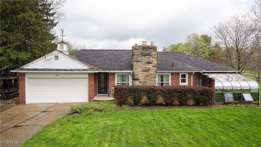 Welcome to 1099 East Garfield Road, Aurora, Ohio
Offered in the highly-rated Aurora School District

Set on 10 breathtaking acres, this rare property offers the perfect balance of natural beauty, privacy, and thoughtful amenities. Gently rolling lawns lead to a picturesque pond, mature woodlands, and meticulously landscaped gardens—all cared for with love and attention over the years.
The home itself is filled with warm character, featuring hardwood floors throughout, a cozy fireplace, and a back porch with serene views of a peaceful creek and charming walking bridge that leads to the rear pond. Explore the walking trails located within the 4 acres of woods.  The Nature Stone front stoop welcomes you to a lifetime home where every season is beautifully framed by nature.

Additional highlights include:
    •    Two-car attached garage
    •    2.5-car outbuilding with separate driveway and electric—perfect for a workshop, hobby space, or additional storage
    •    Utility building conveniently located near the home
    •    Heated greenhouse—ideal for year-round gardening or creating a private retreat with incredible views of rain, snow, and changing seasons
    •    Landscaped water feature and pond equipped with a pump to help maintain lush gardens

This property is truly one-of-a-kind, offering endless opportunities for outdoor enjoyment, gardening, entertaining, and simply soaking in the natural surroundings. Whether you’re looking for a peaceful sanctuary or a forever family home, 1099 E. Garfield Road invites you to experience life at its most beautiful.