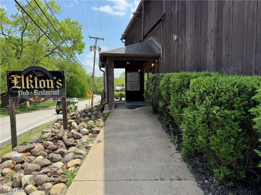 ATTENTION ENTREPRENEURS!!! This is your chance at a rare and historic commercial property located just outside Lisbon, Ohio, offering over 10,000 square feet of versatile space across two stories. Formerly home to a beloved local restaurant and pub, this beautifully converted 1830s barn sits on 2.32 scenic acres near Ohio's smallest covered bridge, providing exceptional charm and visibility for future commercial use. The structure has been thoughtfully modernized while preserving its rustic character, featuring expansive indoor dining areas, dual bars, and ample room for entertainment or private events. The property also boasts a spacious outdoor dining and entertainment area complete with a stage, picnic seating, and on-site paved parking, making it well-suited for weddings, live music, festivals, or seasonal gatherings. A secondary structure on the premises is currently used by the local township as a visitor information center, offering additional visibility and a modest income stream. Utilities include private water and septic, with public sewer now accessible on site for future connection. Heating is provided by forced air, and the building includes central air conditioning and an asphalt/fiberglass roof. With minimal direct competition and a growing local population, Lisbon is a welcoming and underdeveloped market for hospitality, food and beverage, or event-based businesses. The zoning allows for restaurant, brewery, winery, or creative event space use, and the layout is ideal for a variety of business concepts. For buyers interested in a fully equipped operation, the business assets including furniture, fixtures, and equipment are also available for purchase as well.