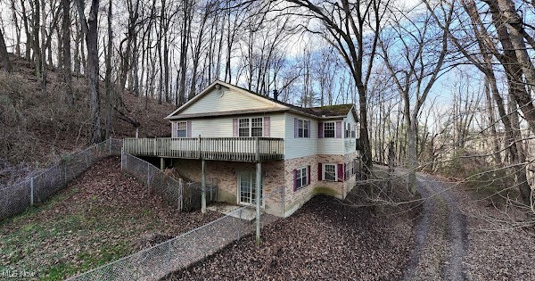First Time Offered ! Beautiful 3 Bedroom 3 Full Bath surrounded by woods on 5.3720 acres just outside of town. Huge Master suite with private bath including jacuzzi tub. Beautiful kitchen and living room with shared fireplace. Basement features large family room with built in sauna ! Large utility room with lots of storage. 2 car attached garage. Big wrap around deck with fenced in back yard.