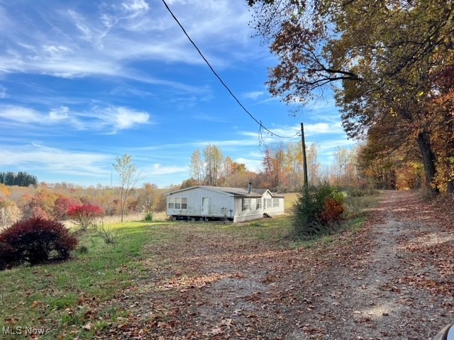 Great investment in a beautiful country setting. This is 3.65 acres on a private street with a mobile home that is in need of repair. There is a well and septic, but the condition is unknown. The mobile home does have a title, it is not taxed as real estate. Sells as-is to a cash buyer only. This is a great opportunity for a rehab or to remove the mobile and build your dream home. The seller is retaining the mineral rights.