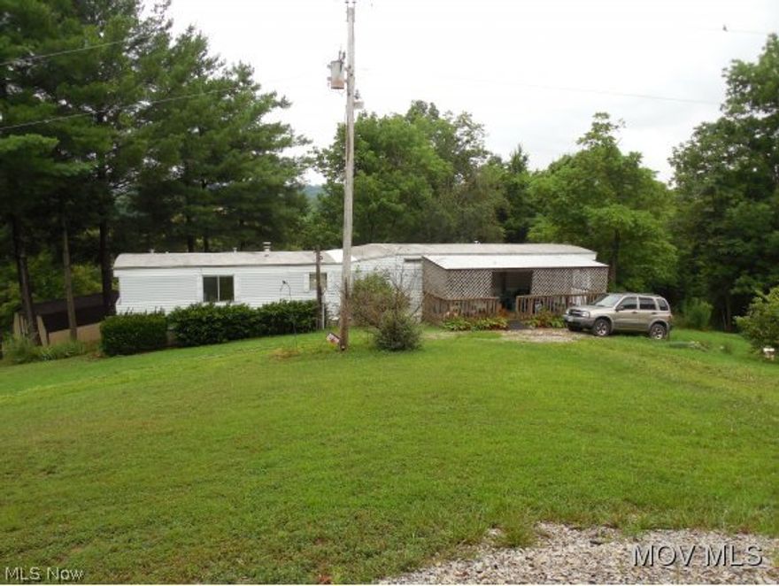 5.18 acres of nice country property which is partially cleared for the single wide and 4 out buildings. Gas well on the property is owned by the current owner and will transfer. This well supplies gas for heating. Community water is available at the road if buyer would like to connect. Rest of acreage is wooded.  Elem: Lowell Elementary School  Elem/Bus: Y  JrHigh: Fort Frye  JrHigh/Bus: Y  High: Fort Frye High School  High/Bus: Y  Fire: VOL  Police: SHF  PossFreeGas: Y  ;SQFT=Fin Bsmt:0, Fin Above:980, Fin Total:980, Unfin Above:0;PRKG= Parking Pad