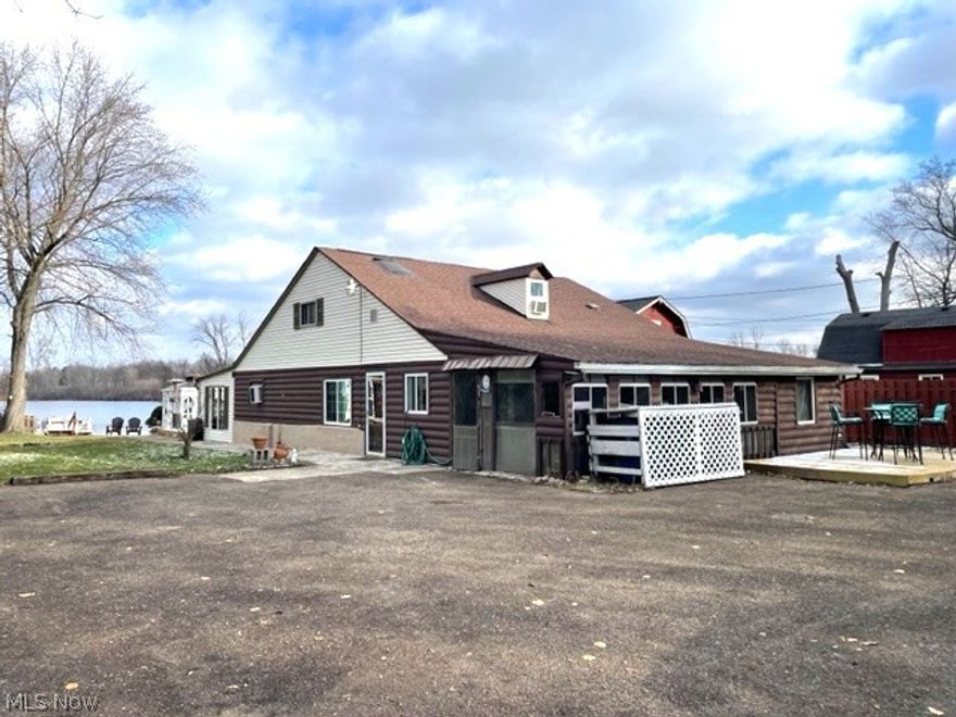 This one may not sit on the MAIN lake but it does connect to it and its HALF the price that you'd pay with this Sq Footage and large lot size.  This cozy waterfront home offers 3 bedrooms and 2 full baths, approx. 1,950 sq ft. per county information, full applianced kitchen, first floor laundry & master bedroom/bath.  Two bedrooms and full bath on 2nd floor, one with vaulted ceiling and skylight.  Two- seasonal rooms off the main living room with plenty of windows overlooking the lake.  The home has 2 decks (front & back), RV Hookup and carport.  New water heater, softener and whole house filter.  If you wanted to be on the water but didn't want to pay the price to be on the main lake, here's your chance.  Dock and pontoon boat will stay as a gift.  No basement, storage area up front.