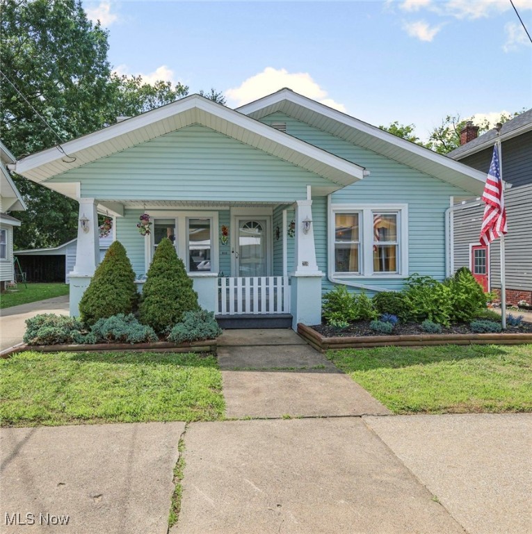 Home-Sweet-Home! Check out this charming and cozy bungalow that has a cottage-like feel, nestled in the city. Inviting curb appeal and relaxing covered front porch is the ideal spot for morning coffee or evening unwinding. Step inside and feel instantly at home in the cheery living room, featuring a fireplace and built-in bookshelves that add character and warmth. This space flows seamlessly into the dining room, highlighted by a built-in corner hutch, perfect for displaying your treasures. The kitchen will astound you with its incredible storage, boasting floor-to-ceiling cupboards. Newer refrigerator and windows add to peace of mind. This delightful home offers 2-3 bedrooms and a full bath, thoughtfully updated with a newer walk-in jacuzzi bathtub shower combination for ultimate relaxation. The unfinished full basement presents a versatile space with a washer and dryer, a pool table that does convey with the home for endless entertainment, and a dedicated workshop area for your hobbies. Then step outside to your private fenced-in backyard oasis, where outdoor living is a dream. Enjoy the concrete patio with built-in seating wall, perfect for al fresco dining, and the convenience of a remote-controlled awning for shade on sunny days. And for the ultimate indulgence, unwind in your very own hot tub under the stars! There's also a separate covered ramp entrance off the side of the house, a concrete driveway and a one-car garage, that provides added convenience and privacy. Don't miss the opportunity to make this Wooster gem yours!