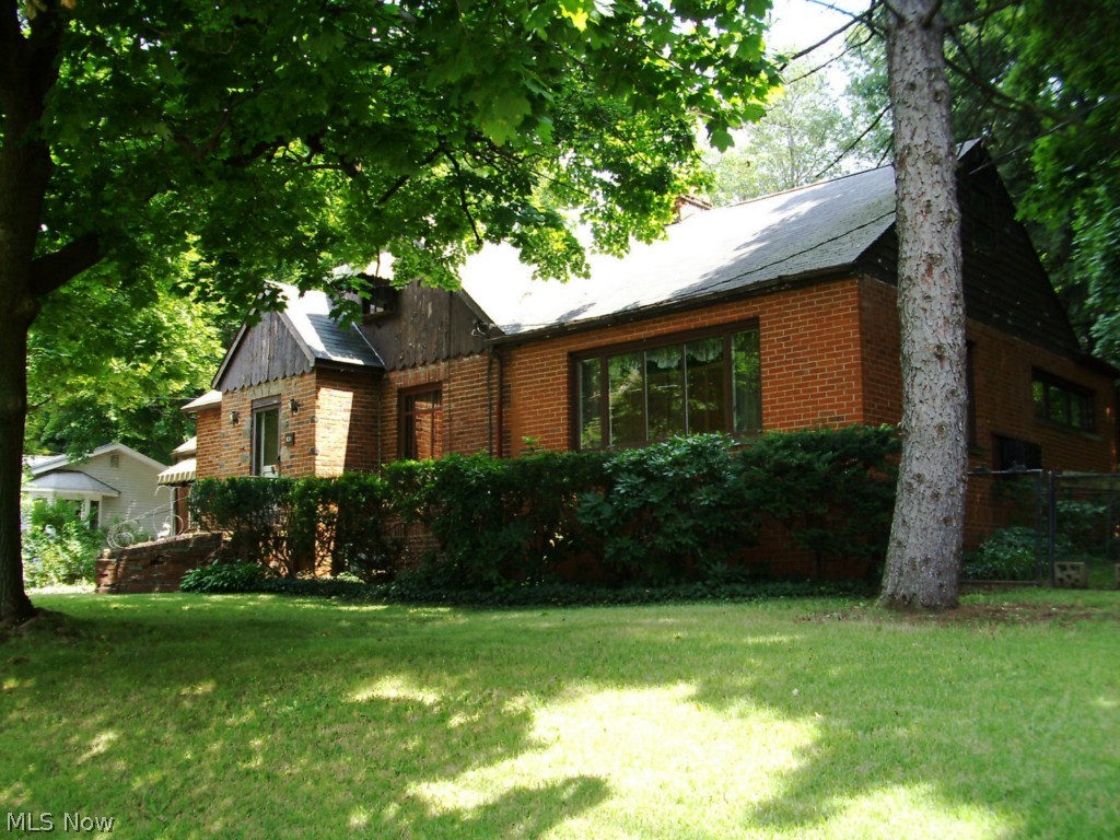 You haven't seen one like this one! Needs work but will be a unique property when finished. Some large living areas, dining, family room, thanks to additions to the original structure. Walk up to knotty pine attic for storage. Currently a sewing room, 3rd bedroom possible with some floor plan changes.
Garage is approx. 24X24 and above is a massive loft for whatever hobby or storage needs you have. Access from the exterior stair case, worth the trip.
Roof was done in 2006, and the electrical service is being updated to 200 amp, plenty for both the house and the garage.
An extra lot is included which is behind the shady backyard. Follow the footpath back to see it, there is an open grassy area and remnants of fence giving you an idea of the size 100X100 (approx. .23acre). Total of both lots is approx. .516 acre.