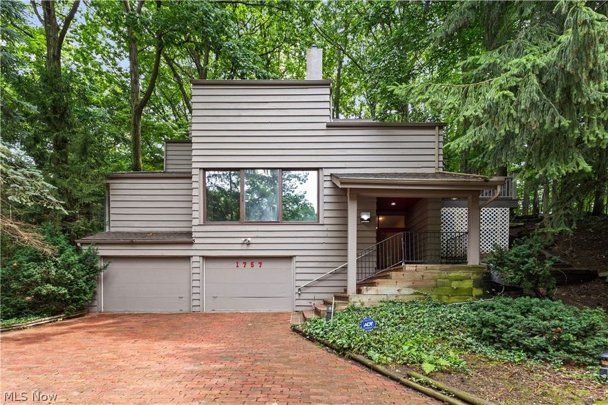 Absolutely spectacular architectural masterpiece in the heart of South Euclid. The home was designed by the renowned architect Richard Fleischman, and was his private residence until 1984...The home seamlessly blends the indoors with the natural wooded surroundings. Glass, wood, stone and a wooded lot all come together in a true delight. The home is compromised of 7 different levels. The ground floor has a 2 car attached garage and elegant foyer, The next level boasts a beautiful formal living area with a stone fireplace. Continue up a 1/2 flight of steps and you will find the kitchen/ dining room level with sliding doors opening to patio. Floating between the living room level and kitchen level is a magnificent open library level. As you continue up a 1/2 flight of steps you enter a bedroom level with 2 bedrooms and an updated bathroom. The following 2 floors feature a Huge family room/ game room area overlooking the lower levels. The top level boasts a huge master suite and master ba