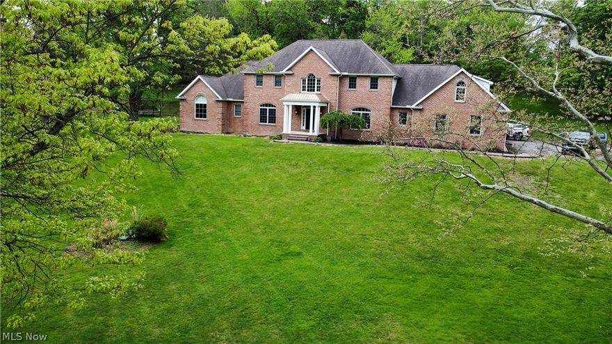 Situated on 2+ landscaped acres, this exceptional 7-bedroom, 4.5-bath residence offers luxury, comfort, and versatility throughout. From the moment you enter, you are welcomed by an open foyer highlighted by a curved staircase and timeless architectural elegance. Designed for both everyday living and entertaining, the spacious floor plan features a formal dining room ideal for hosting family and guests, along with a stunning living room centered around a floor-to-ceiling stone fireplace. The living area flows seamlessly into the kitchen, complete with spacious cabinetry, generous counter space, walk-in pantry, breakfast bar, and casual dining area. The impressive first-floor owner’s suite serves as a private retreat, featuring oversized walk-in closets and a spacious spa-style bath with a jetted tub, dual-head walk-in shower, and double vanity. The main level also includes a private office with French doors opening to the foyer and living room, an additional flex space, convenient laundry room, and a half bath.
Upstairs offers endless possibilities with secondary living areas and multiple bedrooms and optional office. Two bedrooms share a Jack-and-Jill bath with walk-in closet, vanity, and additional storage, while another bedroom features its own private bath. Additionally, you will find a separate bonus suite with a central living area, two additional bedrooms, and full bath.
Convenience continues with both stair and elevator access to all levels, including the expansive basement offering endless storage, recreation, or finishing potential. Outside, enjoy peaceful surroundings from the inviting front porch, multiple patios, and beautifully maintained flower and garden areas. Additional highlights include a storage shed, attached two-car garage, and paved driveway.
This truly remarkable property combines elegance, space, and functionality in a stunning setting you must see to fully appreciate.