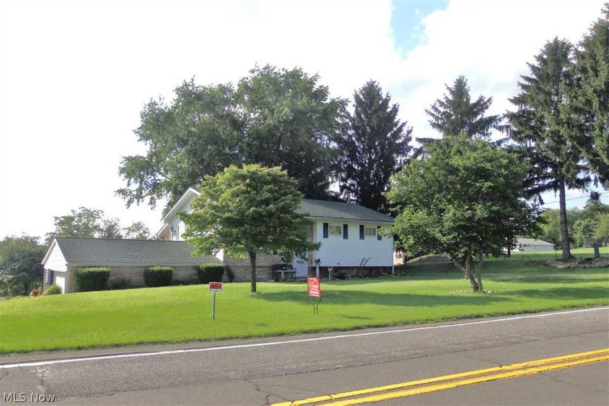 WIDE OPEN SPACES!  One look at the beautifully landscaped, park like setting in the backyard of this 3 BR ranch and you will know this is what you've been searching for! This charming floor plan delivers a living room, finished recreation room with bath and kitchen leading out to a wonderful covered deck overlooking the awesome setting complete with gardens, covered swing and more. 3 car garage, 1 with hoist and work bench. So much to offer!