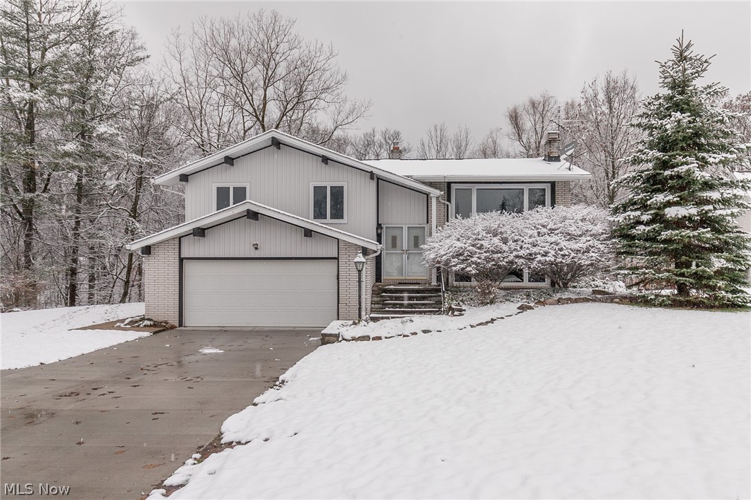 Beautiful 4 bedroom, 2 full bath Brecksville Bi-Level nestled on a quiet cul-de-sac with scenic wooded views! Once inside, you will take notice of the vaulted beamed ceilings, refinished hardwood floors(2018), updated light fixtures(2018), fresh neutral paint & crisp white trim. The nice and open layout supplies a lovely living room with beamed cathedral ceiling, conjoined dining space that leads to the large deck with peaceful wooded views & the clean eat in kitchen with newer appliances, ample cabinet & countertop space & 2nd eating area. 3 generous bedrooms all with refinished hardwood floors & a full bath with double vanities, jetted tub & walk in shower complete the main level. The walk-out lower level boasts a fantastic family room w/ gas fireplace, 4th bedroom, 2nd full bathroom w/ new shower(2018), Laundry/Utility room w/ utility sink; plus access to the beautiful backyard w/ slight ravine & view of a creek off the brand new patio(2018) & a shed. More improvements include a new