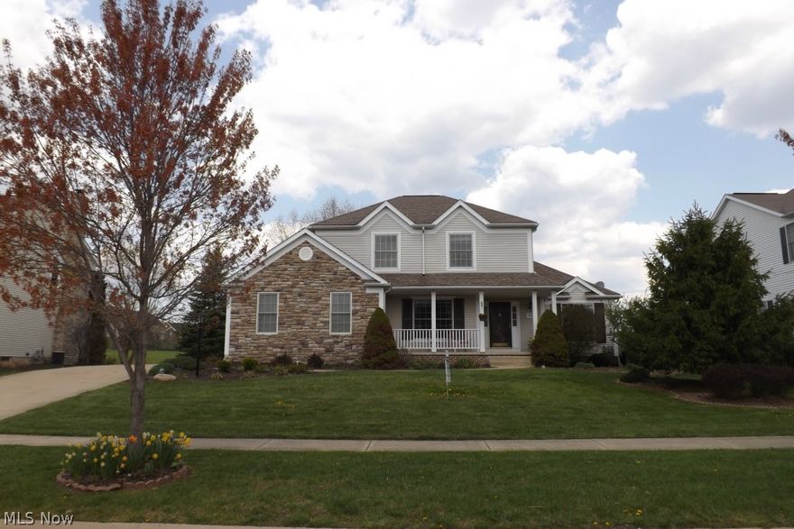 Exceptionally well-maintained and nestled in one of Aurora's beautiful developments, Wellington Estates, and displays a stone-accented front, large two-tiered deck, relaxing front porch and professional landscaping.  The semi-open floor plan displays character and charm featuring an arched entry way into the dining room (currently used as a sitting room), spacious living room with gleaming floors and trendy decor, spacious eat-in kitchen with granite, mosaic, all appliances and a dinette complimented by a custom-built bayed-window seat.  First floor laundry room with a granite bar counter.  The bright owner's suite features a large walk-in closet, master bath with skylight, glamour tub, double sinks, private commode and stand up shower.  Lower level is awesome... wrap around space for a cave and more. Lots of storage.  Cul-de-sac street.  Close to the town center, mall shopping and restaurants.