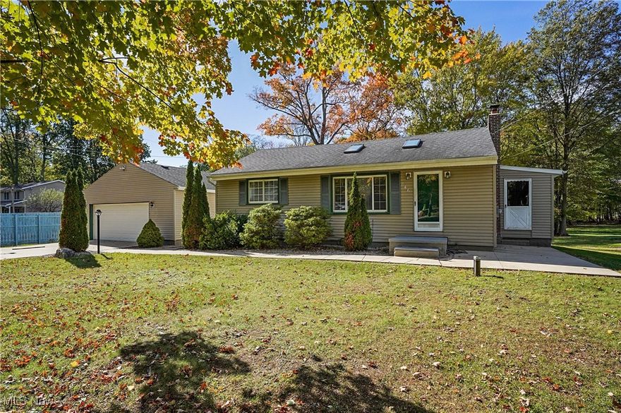 Welcome to this well-maintained ranch offering the perfect blend of country charm and city convenience! Situated on a peaceful dead-end street within the highly sought-after Tallmadge Local School District, this spacious 0.65-acre lot provides plenty of room to relax, play, or entertain—just minutes from metro parks, restaurants, and major expressways. Enjoy the tranquility of suburban living without sacrificing access to everyday amenities. Step inside and be greeted by a freshly painted first floor and brand-new carpeting (2025) throughout. The light-filled family room boasts a stunning vaulted ceiling and two skylights, creating a warm and airy atmosphere perfect for gatherings or quiet evenings at home. It opens seamlessly to a large kitchen and dining area with sliding glass doors leading to a huge wood deck that overlooks the beautiful backyard. The main level also includes: two comfortable bedrooms, one full bathroom, and a mudroom perfect for storing coats, shoes, and gear.  The partially finished basement offers even more living space, with newer carpet, fresh paint, and plumbing already in place for a potential second full bathroom. There’s also abundant storage space throughout. Enjoy peaceful evenings or host gatherings on the covered back deck that overlooks the tranquil backyard.
Additionally, the garage is 2 1/2 car with an extra work room, 220 line,  electric, heat, and water all found in the garage.  The lot also offers an additional three parking spots and a shed. For further entertainment, there is a small basketball court at the back of the lot. Notable updates over the past decade: roof, siding, electric, Hot Water Tank (2023), AC (2022), carpet (2025), interior paint (2025), various well improvements (2017-2023).  For additional peace of mind, the seller is offering a 1-year home warranty.  This home is a rare find! Don’t miss the opportunity to make it yours!
