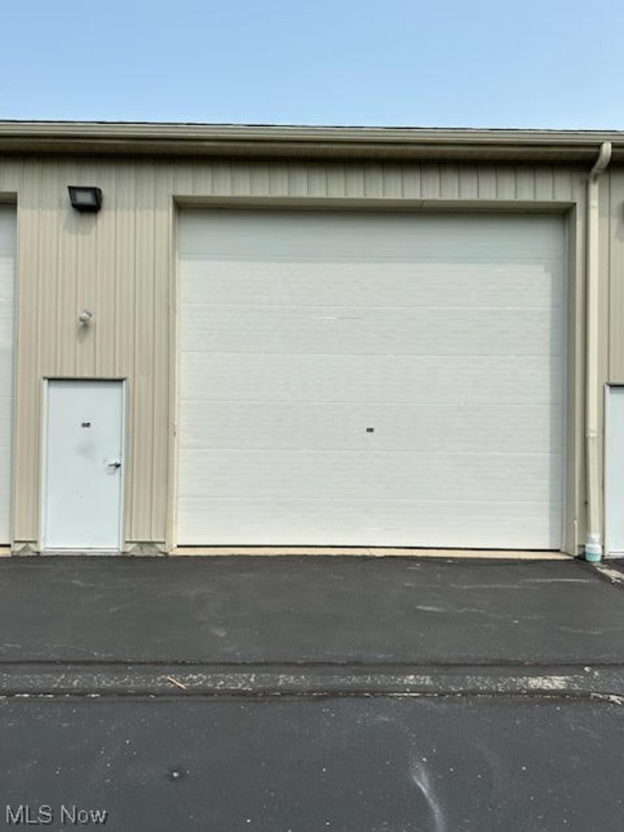 Rare opportunity to own a storage condo in the Avon Lake's Pin Oak Parkway! With a large 990 sf area (Approximately 45' long x 22' wide x 16' high), this mini-warehouse comes equipped with a built-in loft (approx. 226 SF with stairs), ideal for extra storage or to use as an office space. Not only does this unit have a private half bathroom, but it's also furnished with a kitchenette complete with cabinetry, ideal for keeping essentials. This is the perfect space to store RV's, Boats, Cars, Recreational Vehicles and/or any large equipment with an optimally secure, heated space for completing work on various projects.
Door is 16' wide by 14' high.  Flooring is concrete and the walls are insulated structural-steel nicely finished with drywall (painted when last purchased and all holes recently repaired). Unit does include: One electric ceiling-hung heating unit, wall outlets, door opener, base cabinet with sink and wall cabinet above sink base unit. Seller to contribute $500 toward buyer