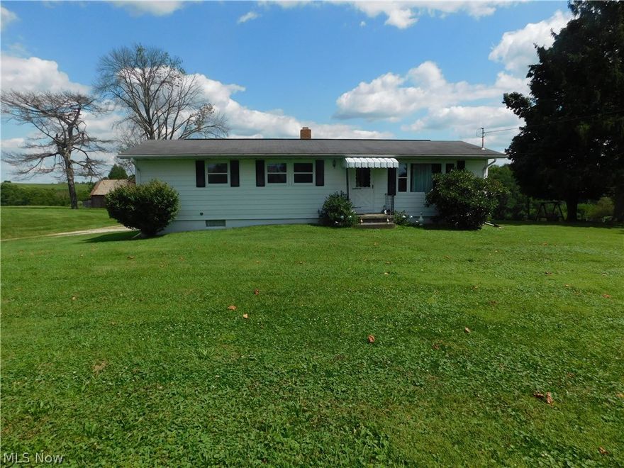 How about 3.14 acres in the country but only 10 minutes from I 70. This home is so comfortable to be in you just feel right at home the minute you walk in. 
A large living room with carpet. Owner thinks there is hard wood floors under carpet. Same in the dining room. Very nice kitchen and the Range, 2 refrigerators, washer and the dryer stay. From the dining room you can walk out onto your deck and enjoy the country view. Then there is three nice bedrooms with hardwood floors. The house is just so nice and homey. The basement is large with a lot of room for rec room or add another bedroom. There is a full bath for your convenience.
There are several buildings on the property and a barn. All in need of work.  
This is just too good of an opportunity to pass up if you are looking for country living.