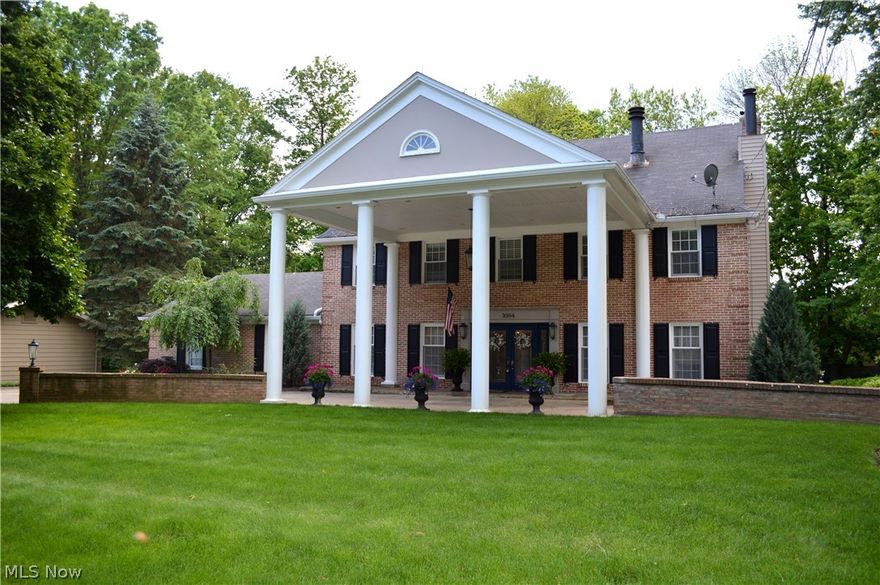 Welcome to this classic 5 BR 5 BA center hall colonial with the best of quality tradition and tasteful updates. Enter the spacious foyer illuminated by beveled glass sidelights to find new travertine flooring which extends into the kitchen area.  The beautiful hardwood staircase continues to the third floor.  A generous formal dining room at the left and formal living room to the right provide plenty of space for entertaining.  A beautiful built-in hideaway bar at the entrance to the family room is perfect for mixing drinks while guests enjoy the woodburning fireplace and extensive brick patio beyond.  The updated kitchen offers hardwood cabinets, solid surface counters and new appliances including a deluxe gas range.  Sliders in the dinette and family room provide ready access to the generous patio offering various seating areas, and paths to the landscaped yard beyond.  Upstairs you will find four bedrooms and two beautifully updated full baths, and the finished third floor offers a