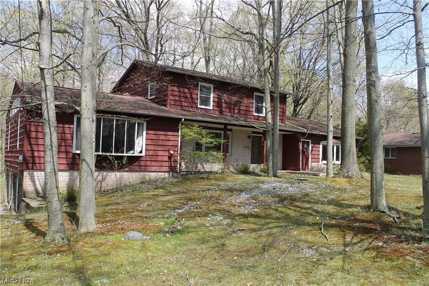 Welcome to your new home.  This large colonial sits on almost a full acre of peacefulness.  The first floor is banked with 1 large family room, and a large second room with an attached bath that could be used as an office or inlaw suite.  Both rooms have multiple very large windows to let in the sunshine and enjoy nature from the inside.     The roomy eat-in kitchen overlooks the treed backyard.  A large deck is easily accessible from the kitchen, as well as a first-floor laundry.  A separate dining room off the spacious family room will accommodate a big table for gatherings.  The stained glass in the family room was handcrafted for your enjoyment.   Upstairs are 4 bedrooms and 2 full baths. with large closets.  This home is ready for the new owner to add their touch to make it their own.  The basement, unfinished, dwalks out to the 2-car garage.  Home is NOT VACANT.  Please do not approach the homeowner.  Call the listing agent or your favorite realtor to set an appointment.  2 Furna